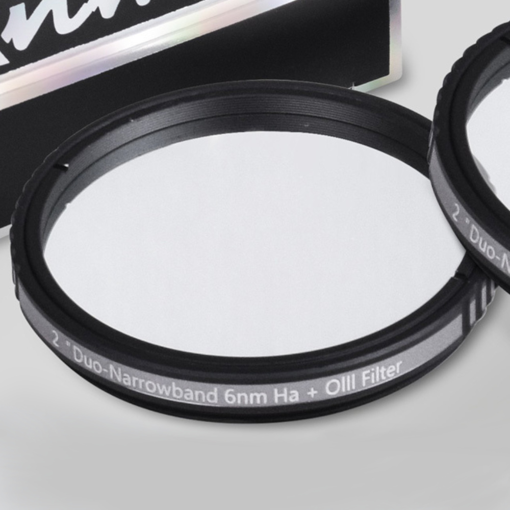 {{Close up of the filter, with another filter resting on top of it and the filter itself propped up against its packaging}}