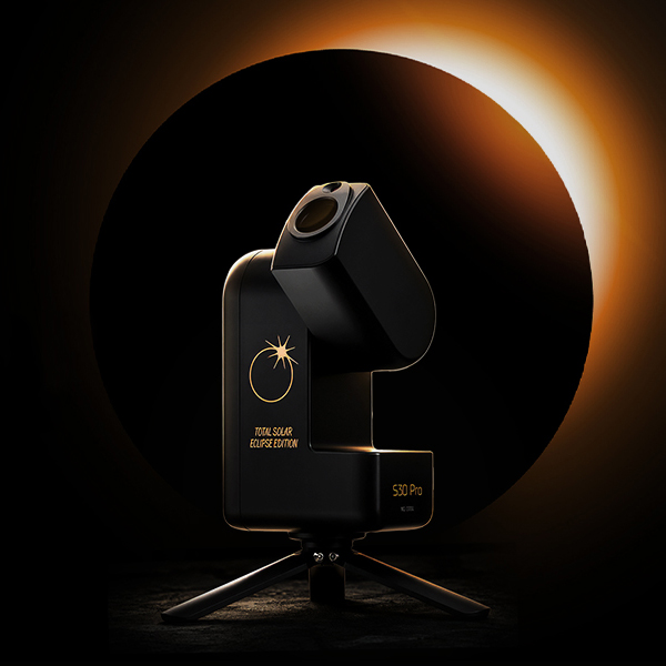 Image of the a Seestar S30 Pro Eclipse Edition in front of a total solar eclipse