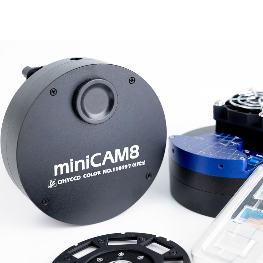 The miniCAM8 set on a table next to another miniCAM8 and a spare carousel