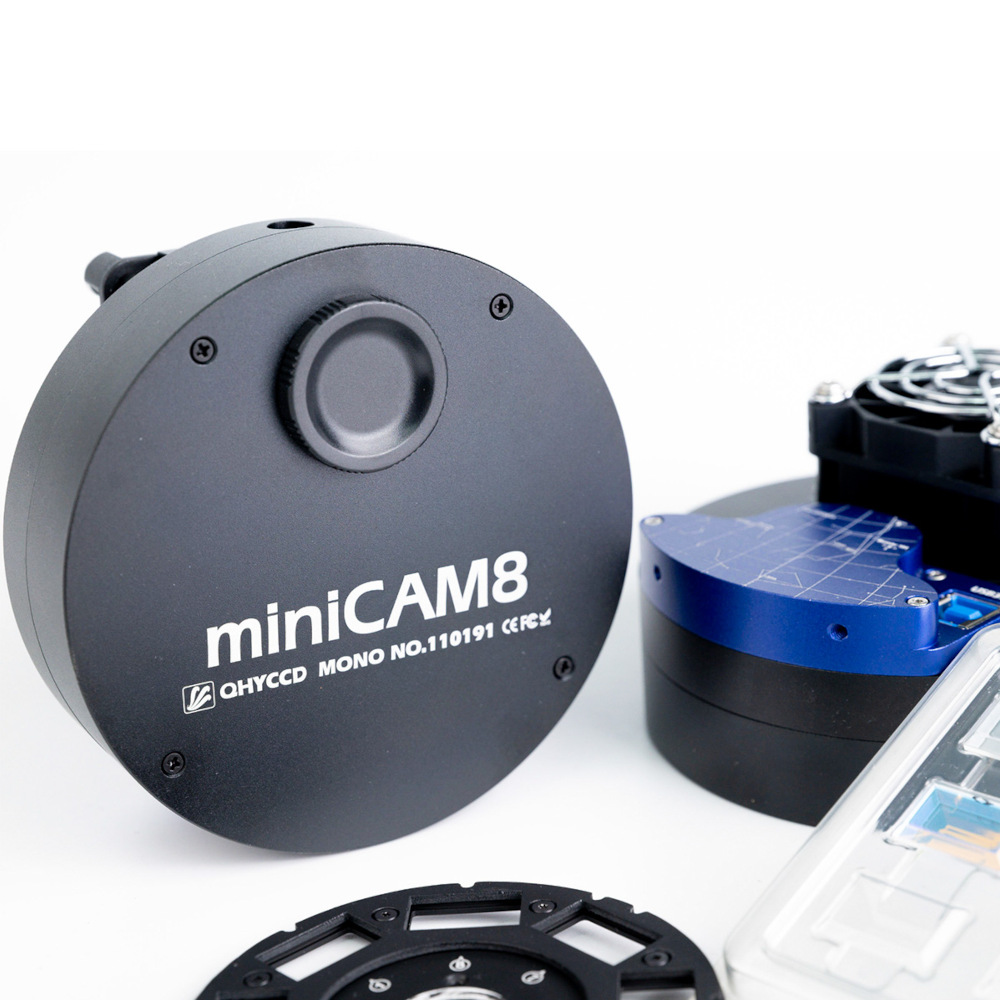 The miniCAM8 set on a table next to another miniCAM8 and a spare carousel